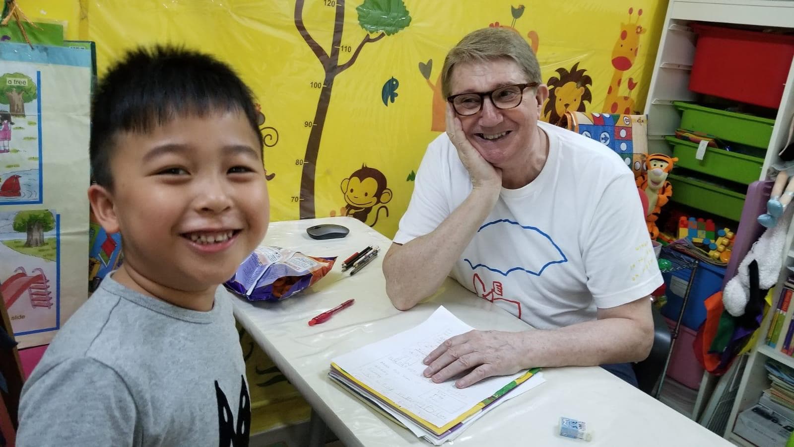 Teacher and student working together at a desk